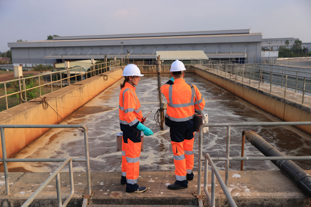 two water management professionals on site